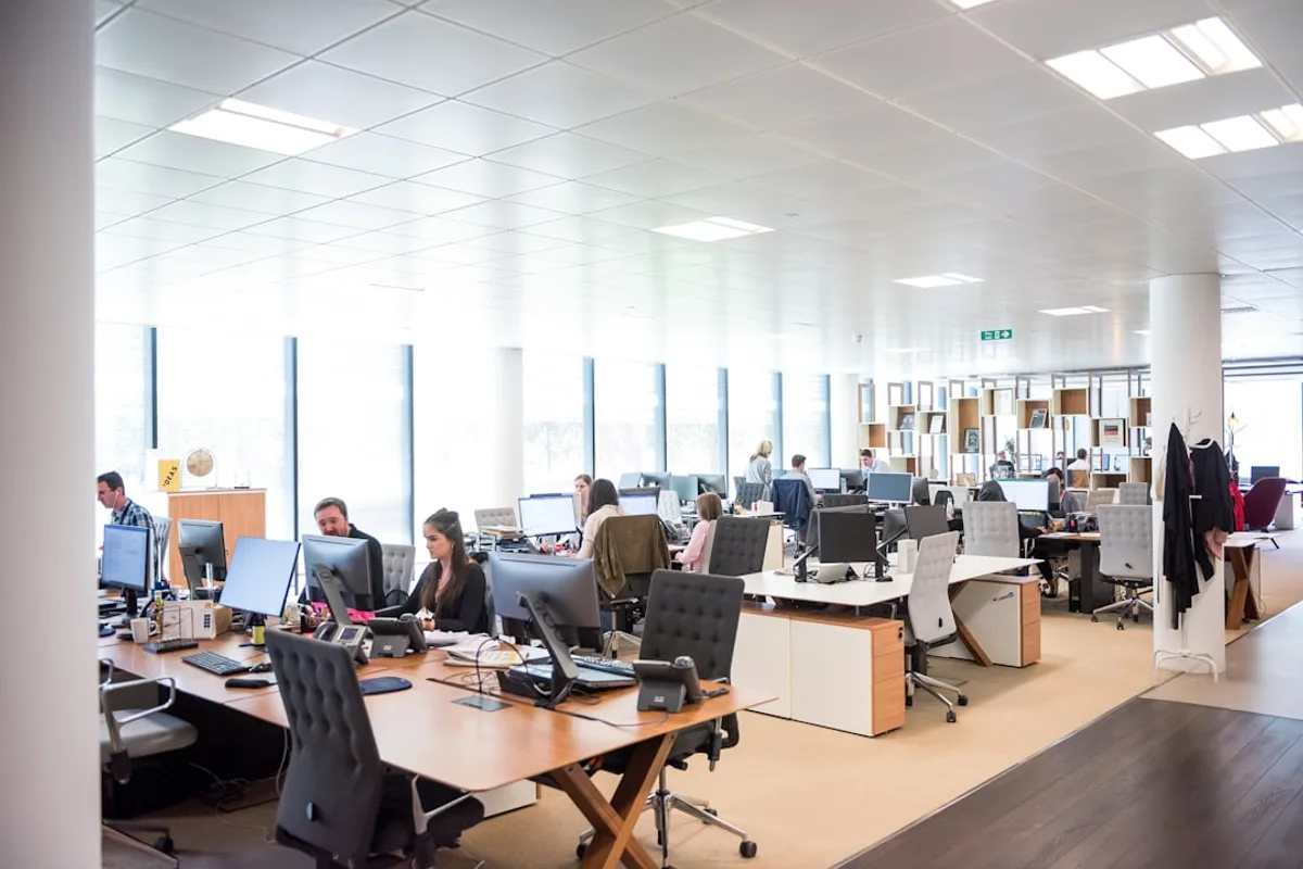 People working at desks in a professional open office environment
